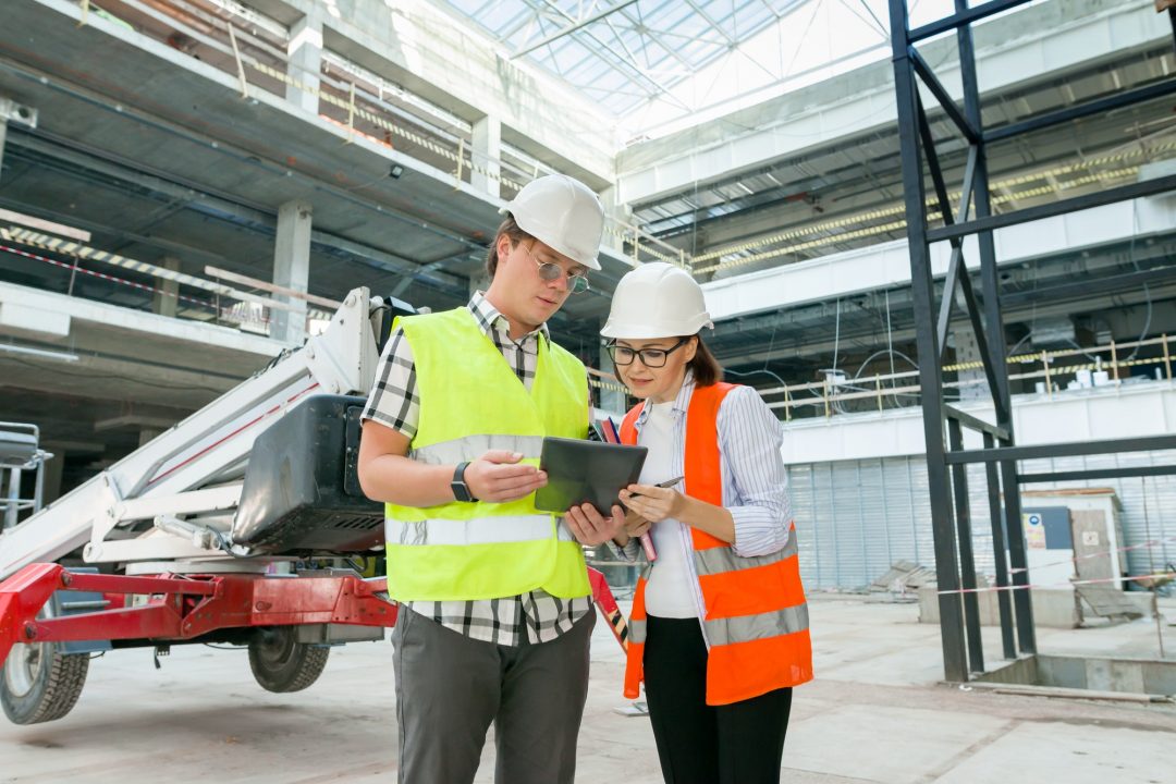 industrial portrait of male and female construction engineers